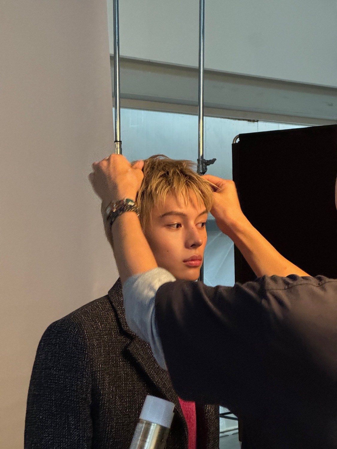 Behind the scenes at the Vogue Man Korea shoot, James of CORTIS getting his hair styled