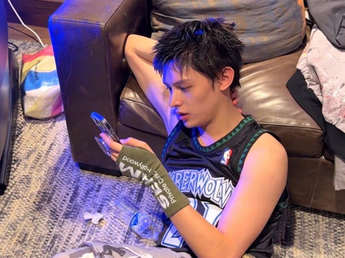 James of CORTIS on his phone