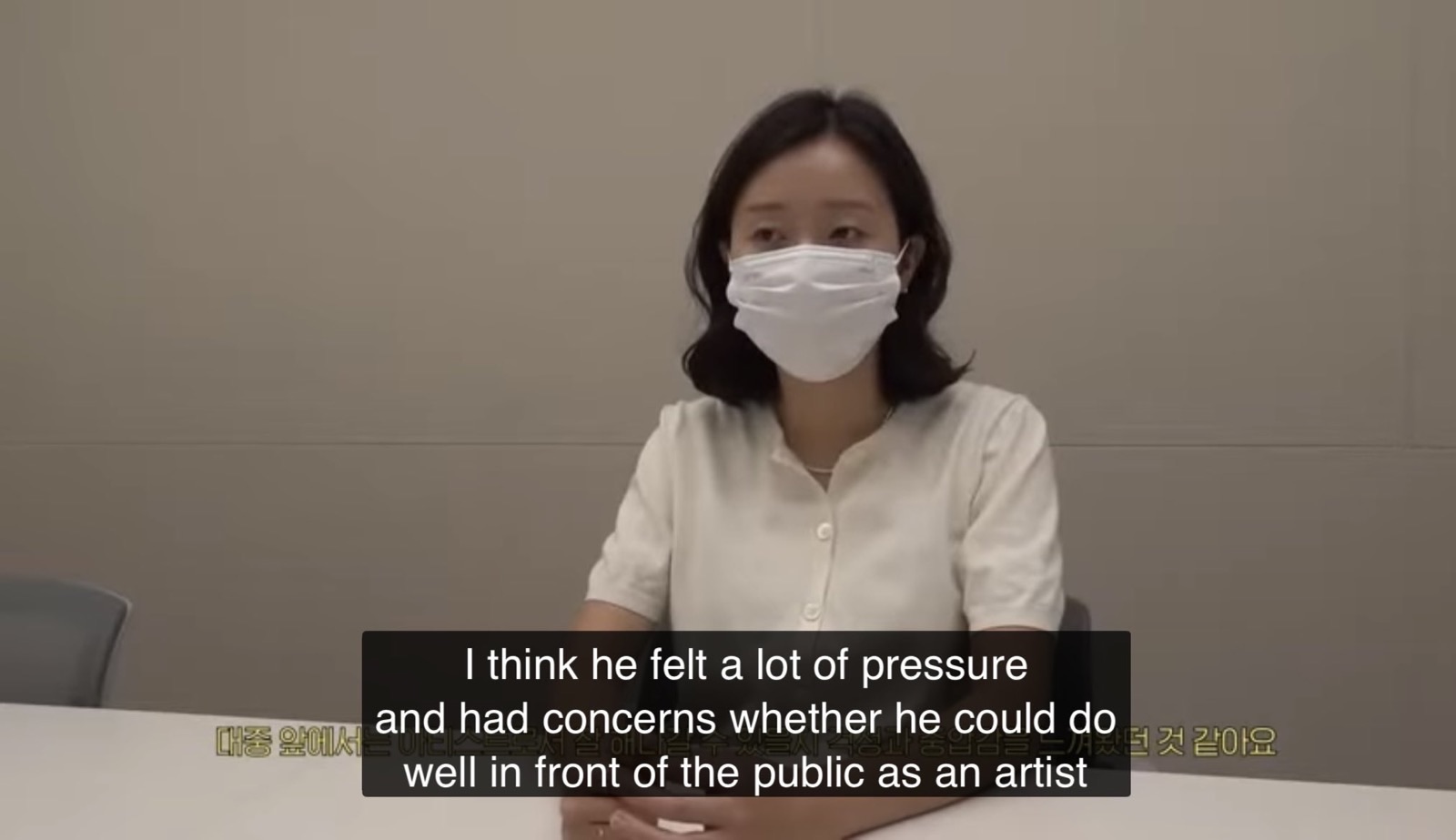 A Big Hit staff member speaking to camera about the pressure Leo felt